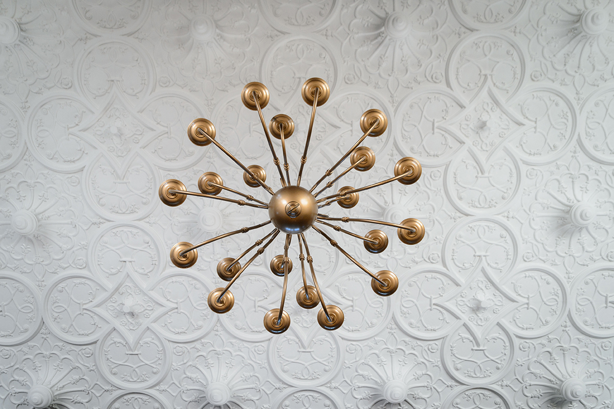 Chandelier against a detailed ceiling in Branford House